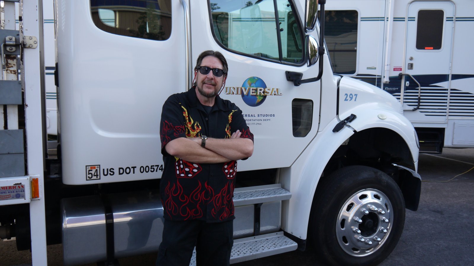 Behind the scenes beside a studio production truck
