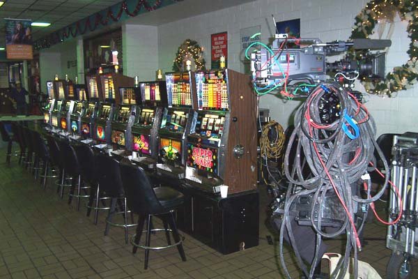 Slot-machine props beside a production camera