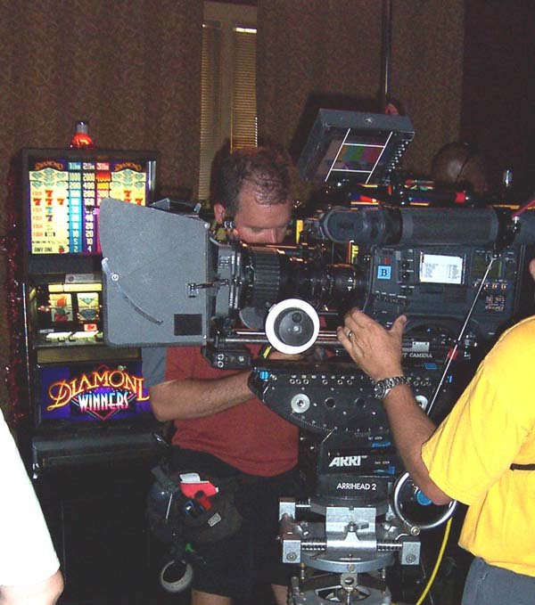 Film crew working beside a slot-machine prop